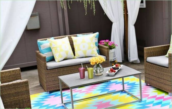 Fonott bútorok és feltűnő szőnyeg a saját verandán Veranda design - fonott bútorok és színes szőnyegek